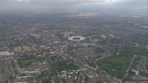 AERIAL United Kingdom-Emirates Stadium 2006: New Arsenal Emirates football Stadium and surrounding area including Finsbury park, zooming in to look onto football pitch within stadium