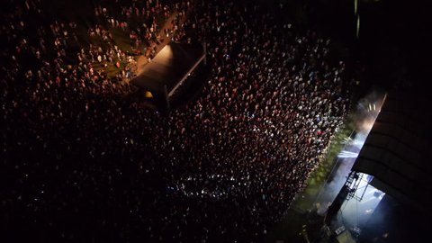 AERIAL: Crowd of people dancing on a music festival