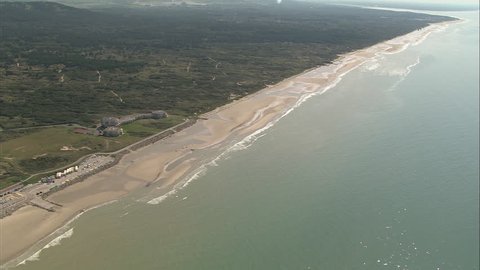 AERIAL France-Opal Coast 2006: Beach to the south of Hardelot-Plage, waves breaking, long sandy stretch, diagonal pan