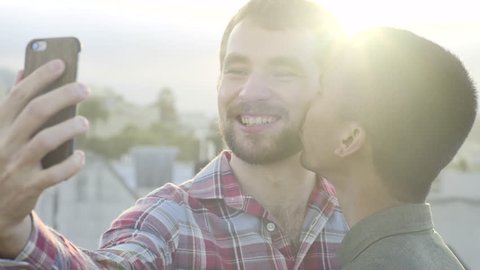 Cute Gay Couple Pose For Selfie With A Kiss On The Cheek, Shot In 4K