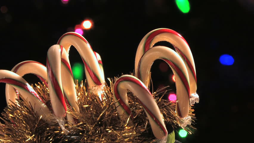 Candy canes rotating in holiday scene. (HD)