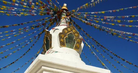 4k buddhist white stupa & flying prayer flags with blue sky background,shangrila yunnan,china. gh2_10502_4k