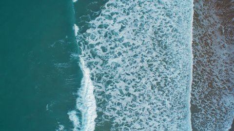Overhead Aerial Drone Footage of Serene Ocean Waves Breaking on Shore Creating Texture. HD 1080 Video.