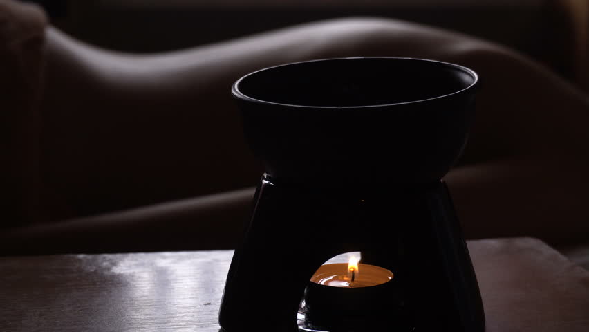 Ayurveda Abyanga Massage concept. Beautiful young woman reciving relxing Massage from Professional Masseur, Man Pours oil on her back