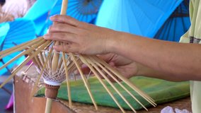Female working handmade umbrella of the Bo Sang village Chiang mai, Thailand.