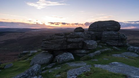 Beautiful sunset time lapse. Taken on Dartmoor, sun setting in the distance behind the Tor. 