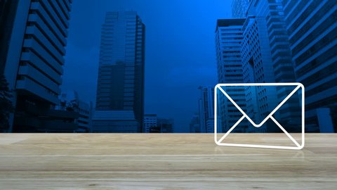 Mail icon on wooden table over modern office city tower background, Contact us concept