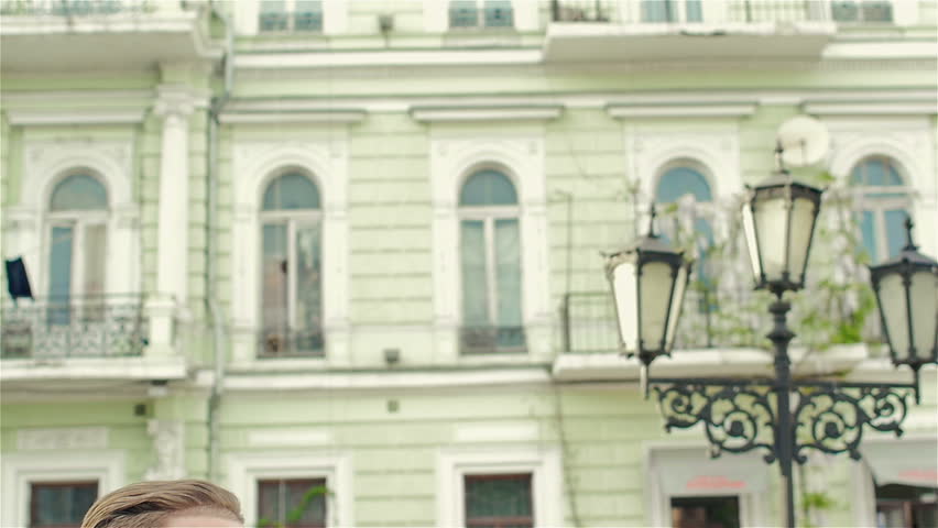 Adult, attractive man sitting on a bench making entries in the notebook