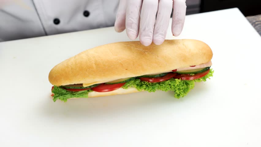 Hands of chef, sandwich. Fresh bun and vegetables. | Shutterstock HD Video #1006565902