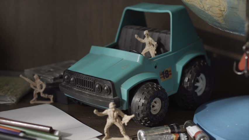 Toy Soldiers and Tanks. Miniature toy soldiers on board