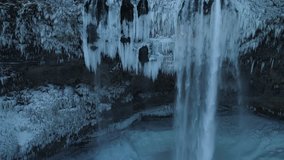 Waterfall View from Above in Winter. Frozen Waterfall Full of Icicles. Arctic Environment. Iceland. - Powered by Shutterstock - Get 15% off with code: PIKWIZARD15