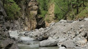 Beautiful water in a mountain river in slow motion video. Shooting speed 60fps, slow motion. Live shooting of the most beautiful nature river mountain water. The camera is static.
