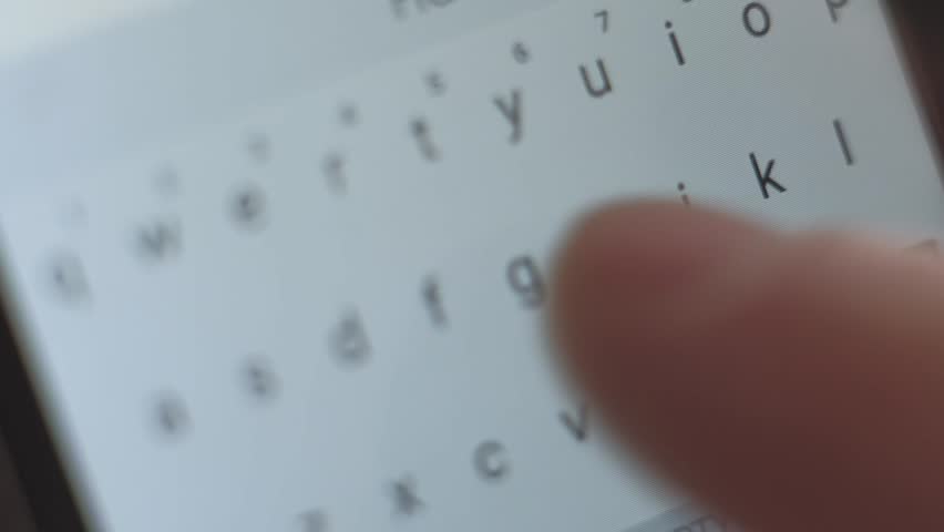 macro shoot - male send the message on his smartphone, typing text, close up of letters on the screen digital devise