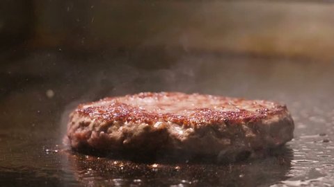 Cooking beef and pork patty for burger. Meat roasted at kitchen. Slow motion. HD