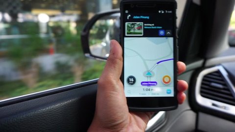 MALAYSIA, Kuala Lumpur, December 19, 2017: The hand is holding a smart phone waze application to show the city's road direction.