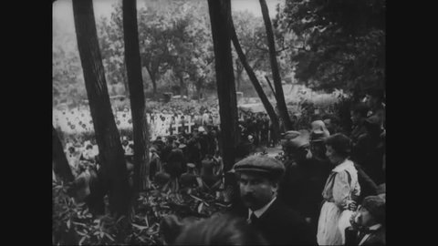 CIRCA - 1919 - Officers and officials in the presidential party of Woodrow Wilson gather near graves in a cemetery at Suresnes in France.