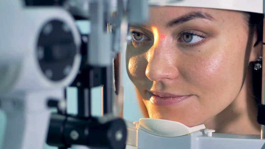 A woman holds eyes open during an optical exam at a ophthalmologist office. Royalty-Free Stock Footage #1006602262