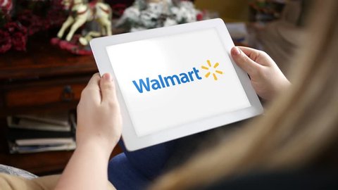 Clarion, PA  - Jan 22 2017 - Woman looking at the Walmart logo on her tablet