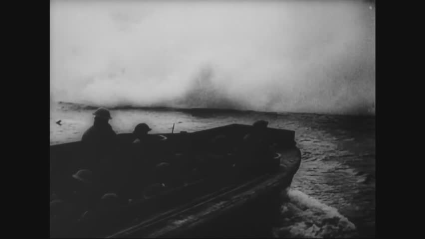 CIRCA - 1944 - Allied soldiers rush the beach ready for action and taking fire on D-Day.