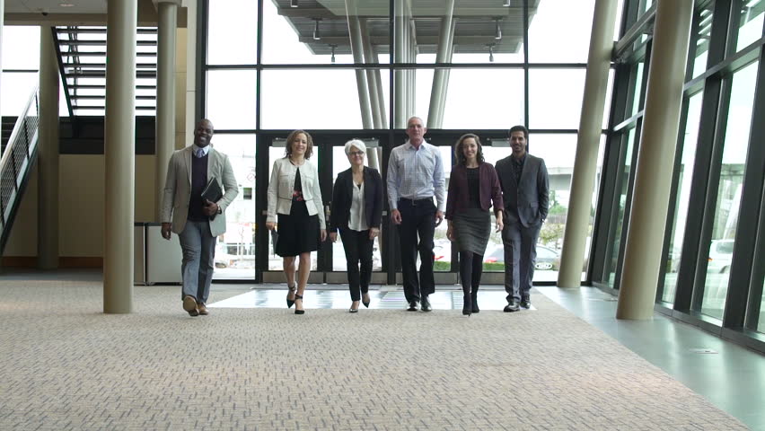Small group of people walking towards camera at a convention center Royalty-Free Stock Footage #1006607014
