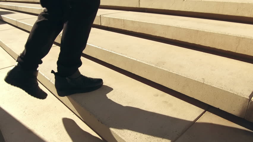 Climbing a stairs, low angle shot.
Following some feet that go up a concrete stairs.Side view. Abstract Concept of improve, success, effort. Royalty-Free Stock Footage #1006610026