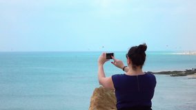 High quality video of woman taking a picture on the vacation on the fuerteventura island in real 1080p slow motion 120fps