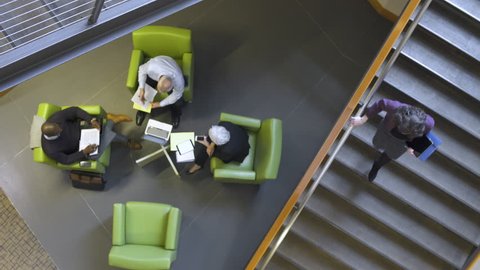 Four people having an informal meeting in a lobby