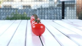 Red tomato cherry over wooden background