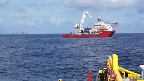 Offshore vessel recover pipe spool in the sub sea during gas pipeline installation project at Sarawak Operation, South China Sea,Malaysia. 