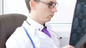 Medical doctor writing prescription on his clipboard in his office. 4K UltraHD video