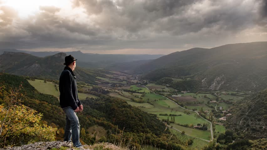 man looking at the cloudy sky with stormy lightning
