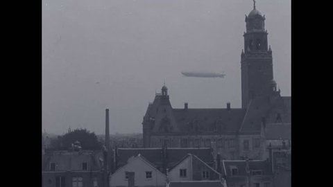 CIRCA 1920s, 1930s - The Graf Zeppelin flies above Dutch cities and countryside.