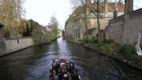 Bruges, Belgium - November 18, 2017; Tourist boats on Bruges canal in Belgium. Bruges is one of the popular city with touristic attractions in Belgium.