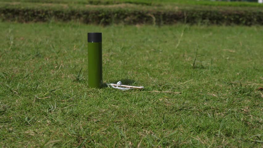 Barefoot Sport Woman Legs Stretching On Green Grass In Park With Smartwatch