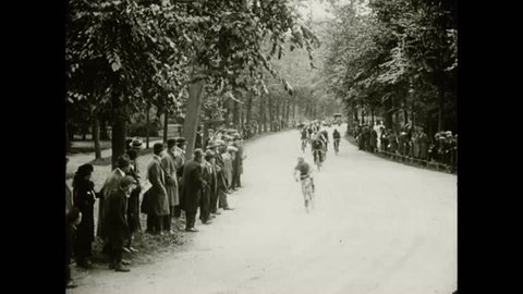 CIRCA 1923 - Men race through Vondelpark on bicycles, motorcycles, and in sidecars.
