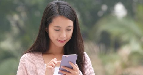 Woman look at smart phone at outdoor