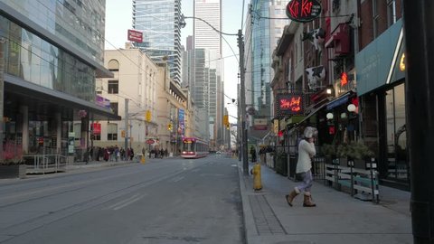 Toronto, Ontario / Canada - January 20th 2018: King Street looking East towards John Street, during King street transit pilot project, as streetcar, pedestrian, and car traffic pass restaurants