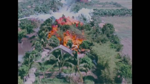 CIRCA 2010s - Napalm is dropped on villages during the Vietnam War causing massive fireballs and destruction.
