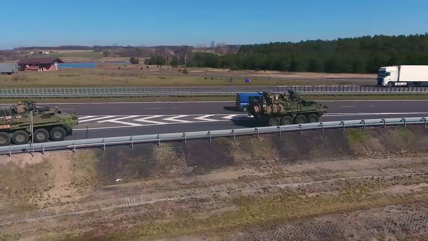 CIRCA 2010s - A NATO convoy led by American tanks moves along a European highway.