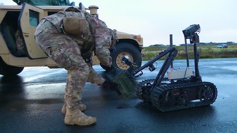 CIRCA 2010s - U.S. air force uses a remote control robot to defuse a simulated car bomb with an improvised explosive device.