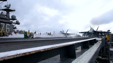 CIRCA 2010s - Navy jets take off from a U.S. aircraft carrier.