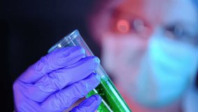 Scientist working with chemicals in laboratory, female researcher analyzing liquid reagent in lab glassware - Powered by Shutterstock - Get 15% off with code: PIKWIZARD15