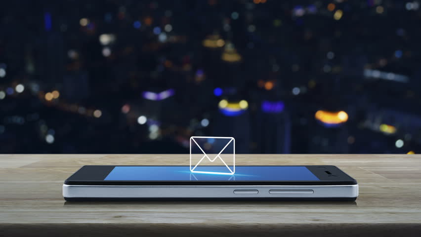 Email icon on modern smart phone screen on wooden table over blur colorful night light city tower, Business communication concept | Shutterstock HD Video #1006674556