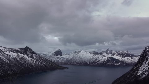 Winter Norway. Senja island. Heavy clouds over the fjord and mountains. Fast motion