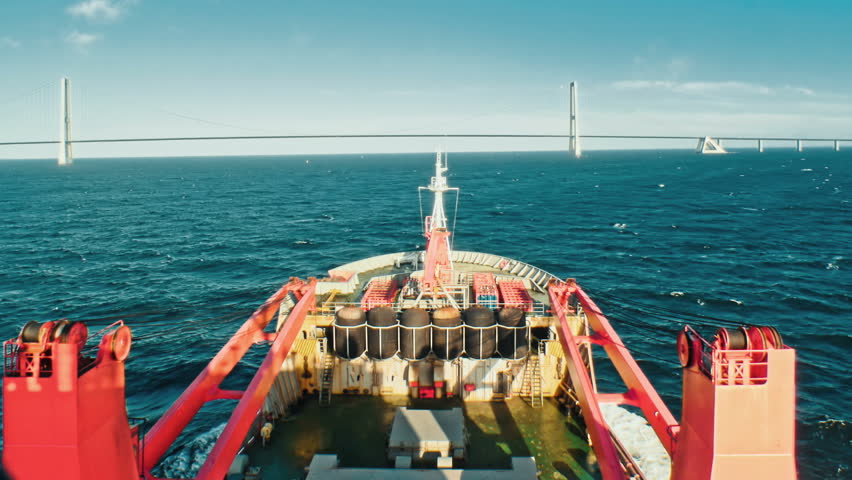 Cargo freight ship sailing away at the open sea