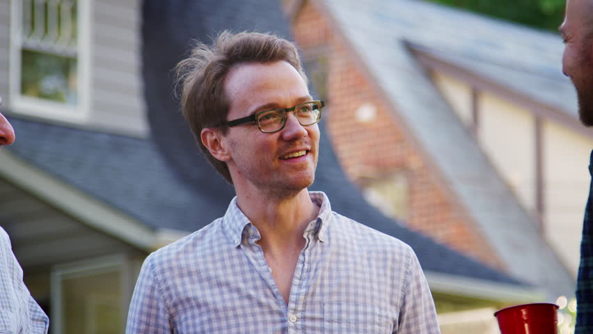 Four neighbours talking at a block party