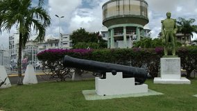 Short pan of statue to Mortenol and two old cannons outside of cruise ship docks in Pointe-a-Pitre, Guadeloupe