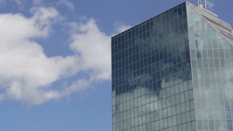 Modern business building  with clouds reflection
