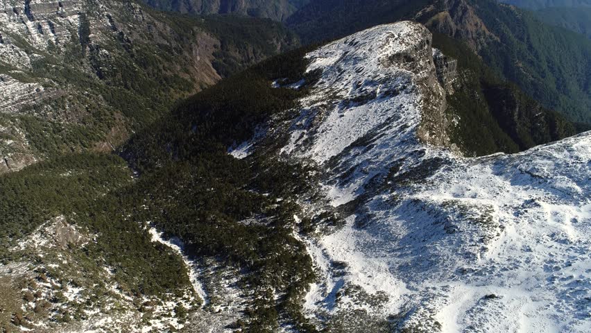 Aerial flight over snowy Mountain Xue landscape at central Taiwan, It is the second highest mountain in Taiwan and in East Asia, at 3,886 m or12,749 ft above sea level. 