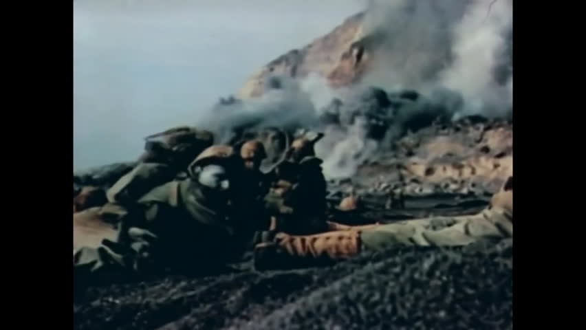 CIRCA 1945 - US Marines take out machine gun nests as they advance on Iwo Jima.